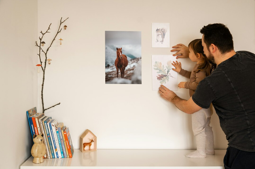 European man and woman in their thirties reviewing archival photographs at a desk